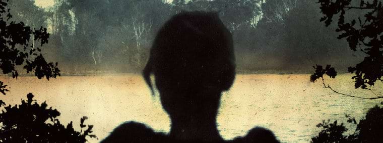 Detail of the art for Deadwing's album cover, showing the silhouette of a woman looking at a lake.
